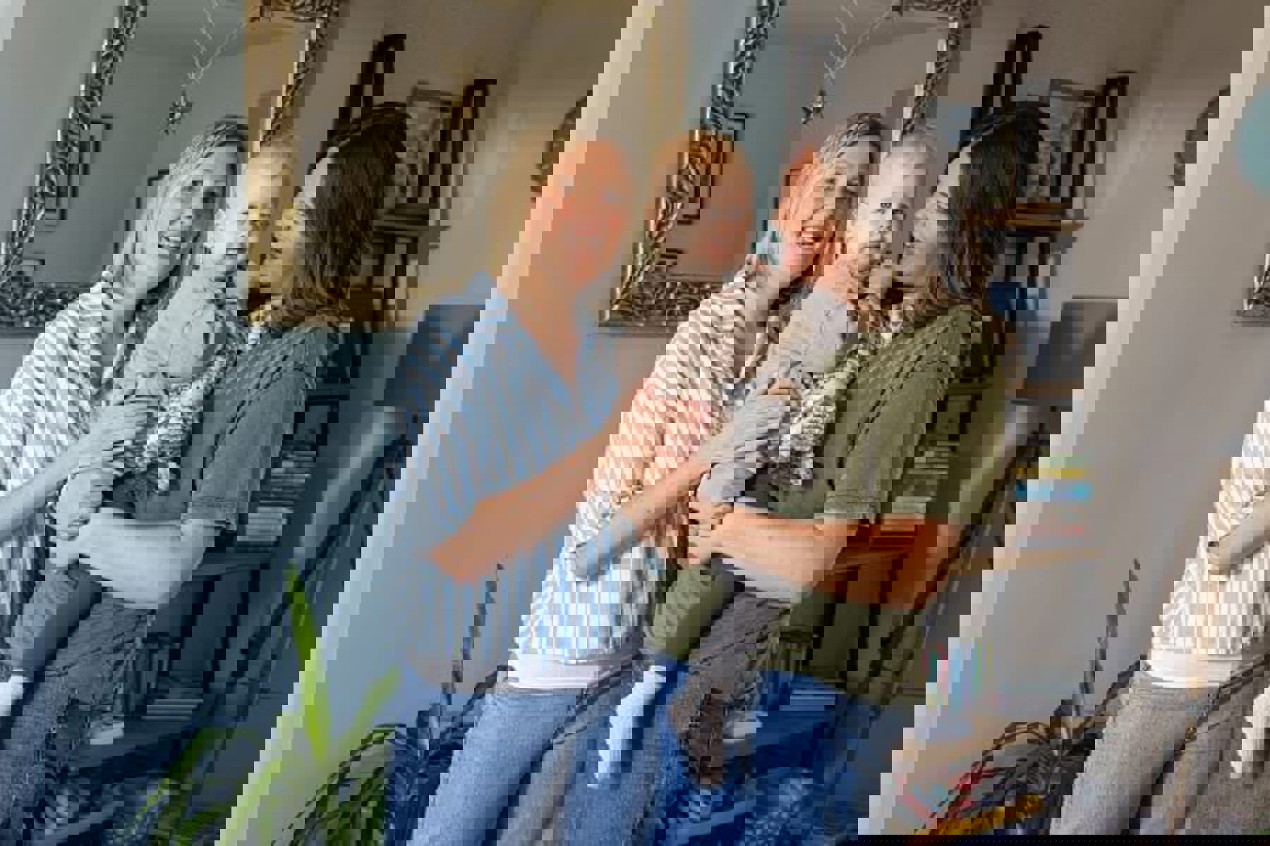 Women Holding Young Child Smiling Stripey Shirt