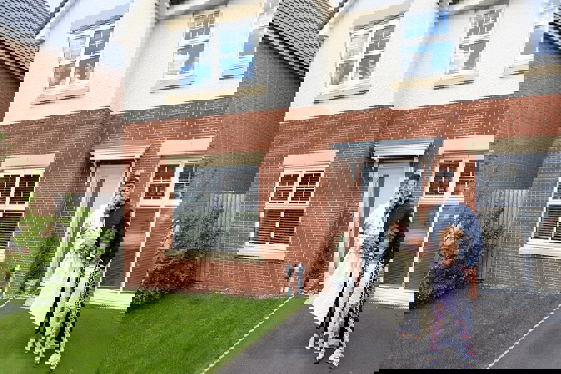 Couple Standing At New Home Front Door