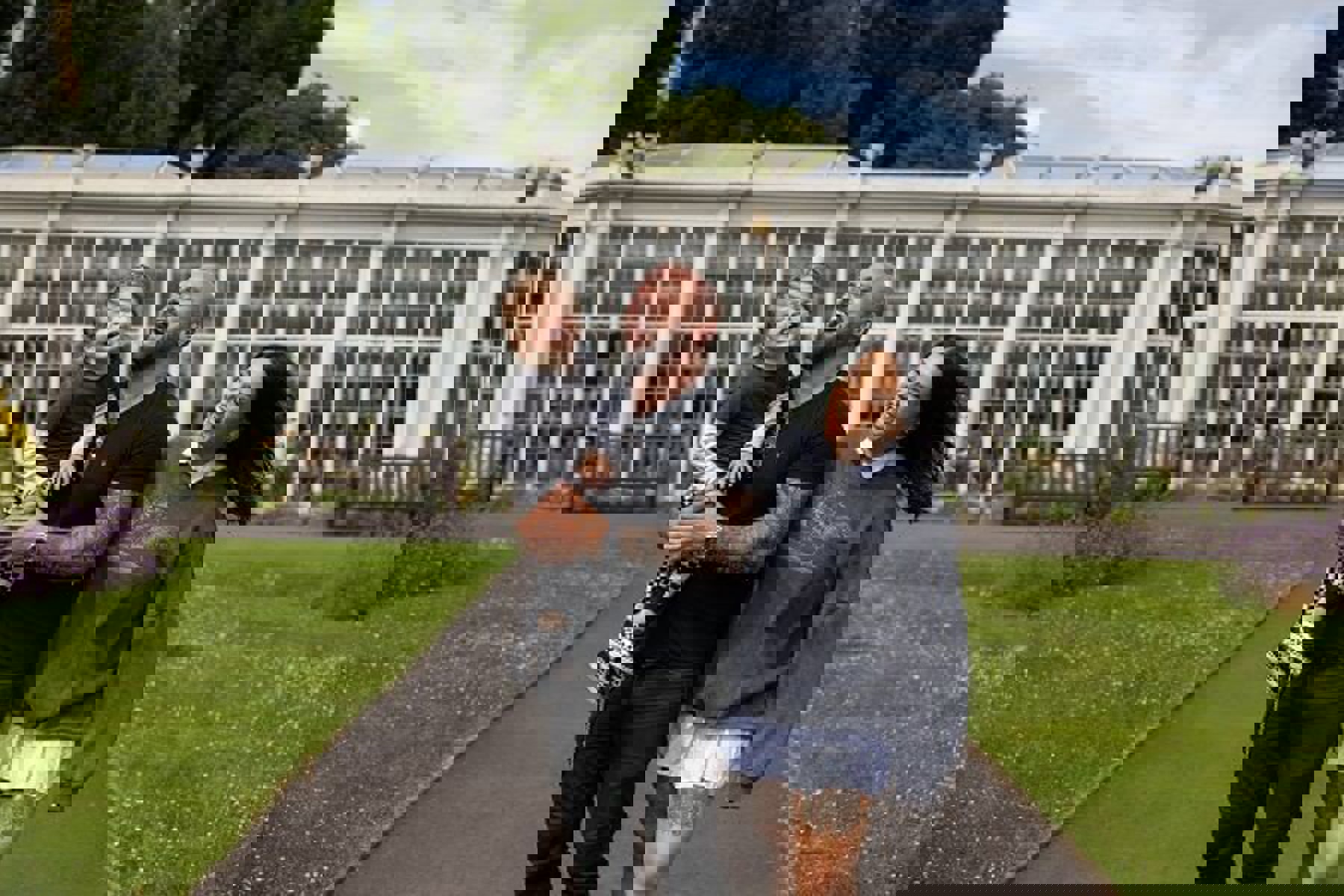 Couple Laughing With Child In Arms