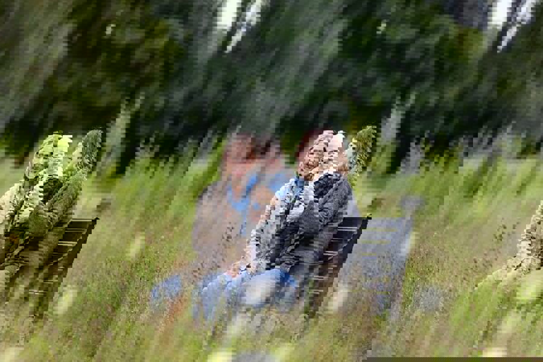 Couple Sitting On Bench With Baby