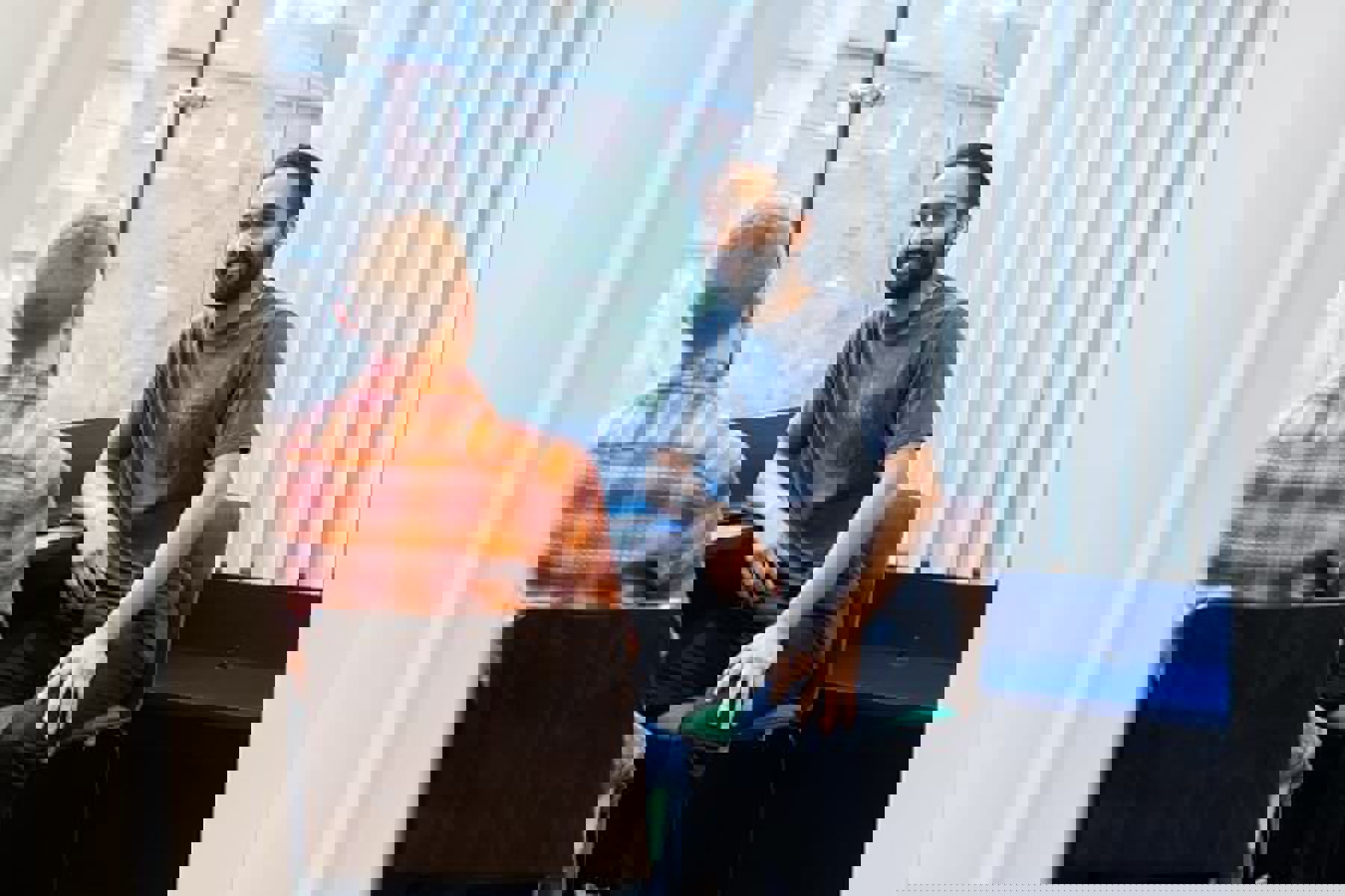 Two Colleages Talking On Chairs