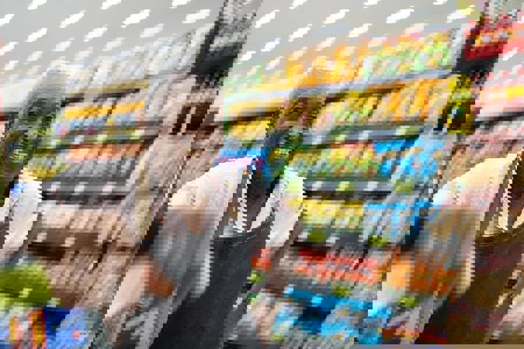 Shop Keeper Standing In Front Of Crisps